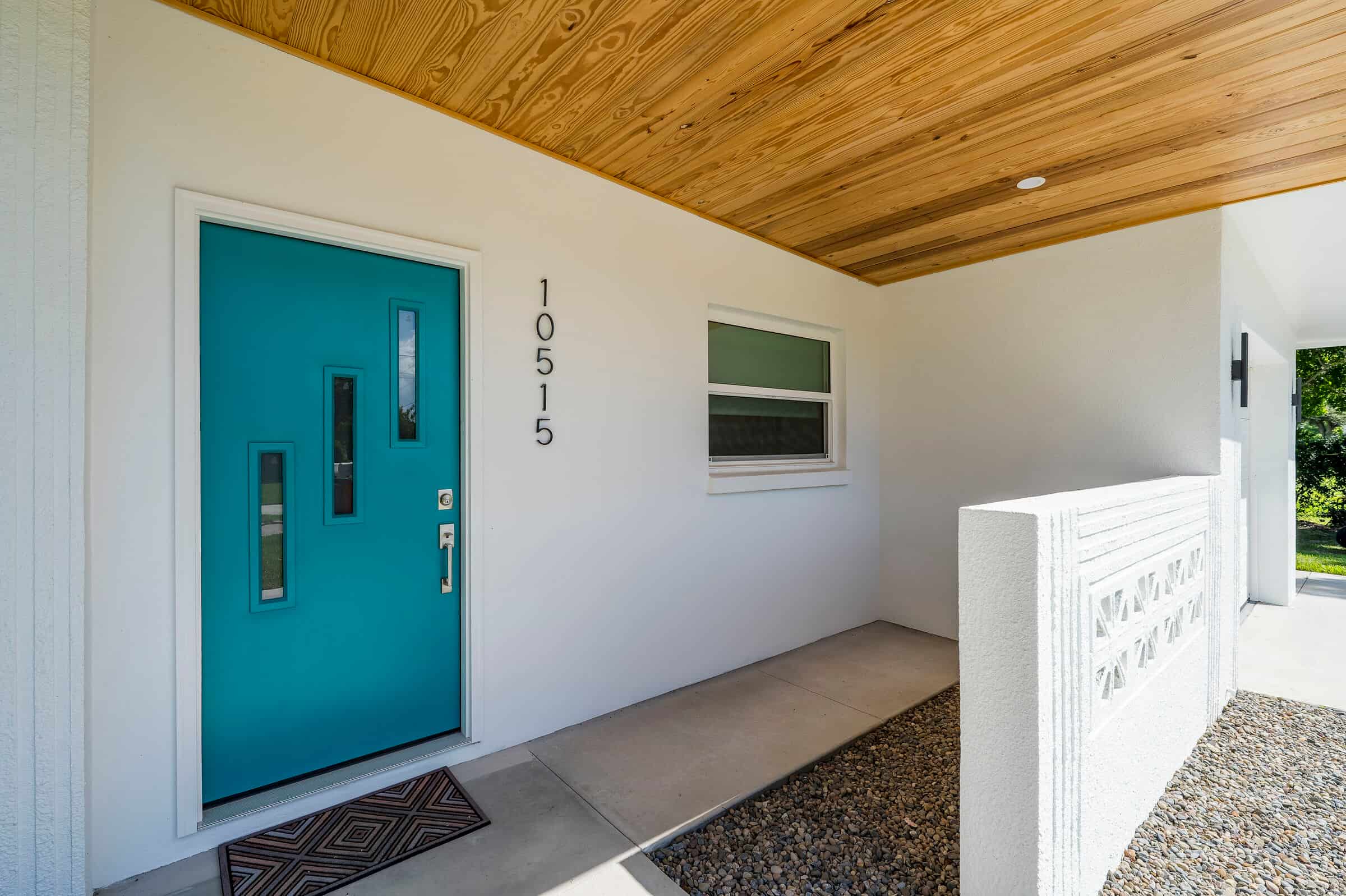 Covered entrance and turquoise front door