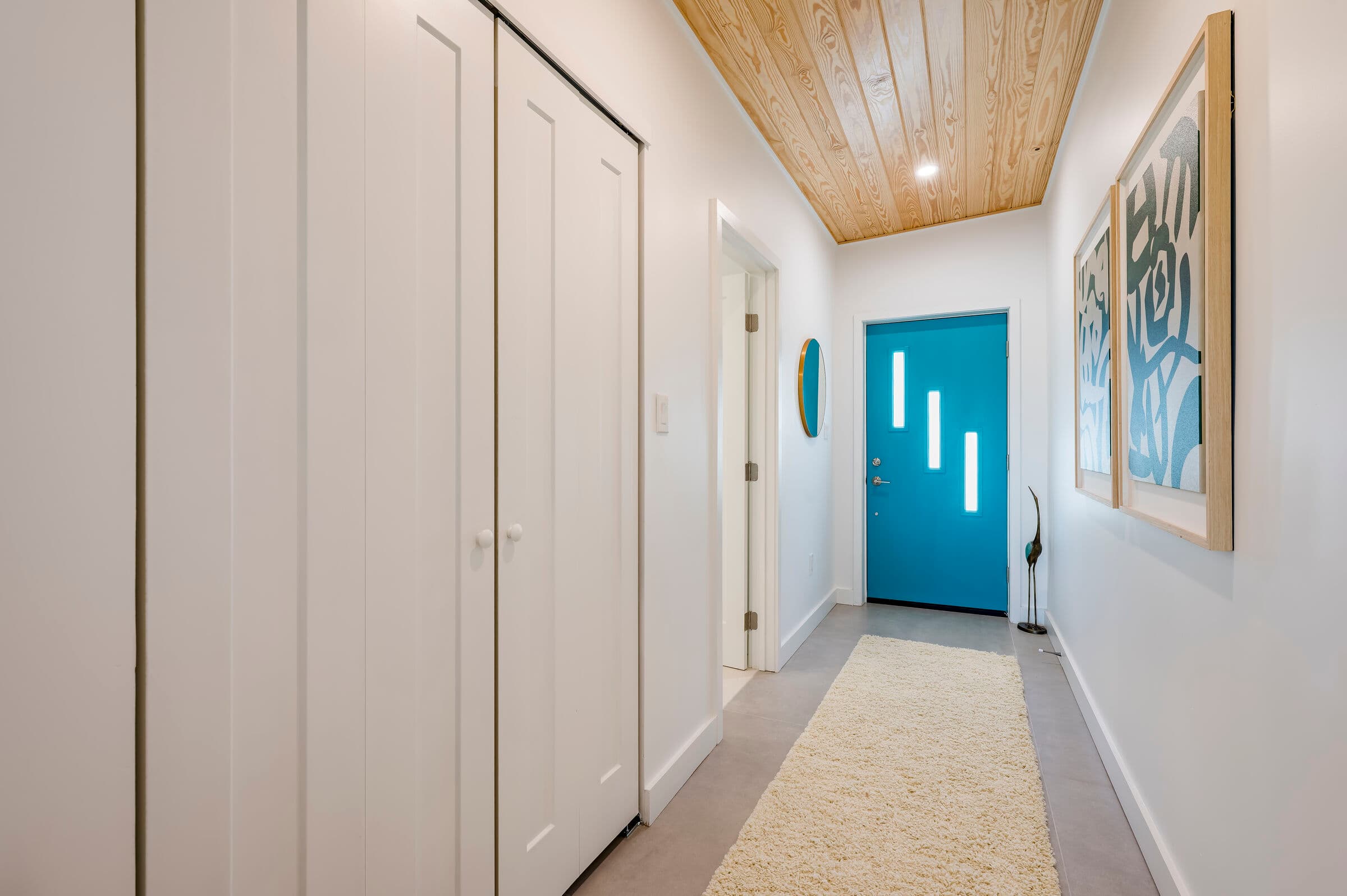 Entry hallway with turquoise front door