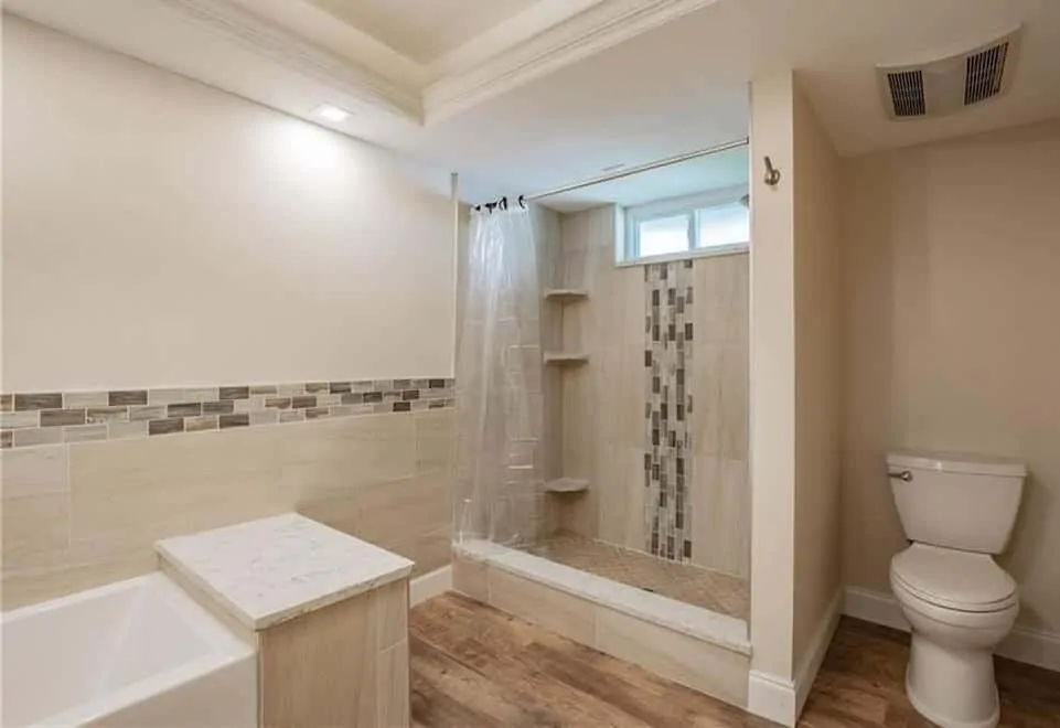 bath condo remodel featuring coordinated shower and wall tile