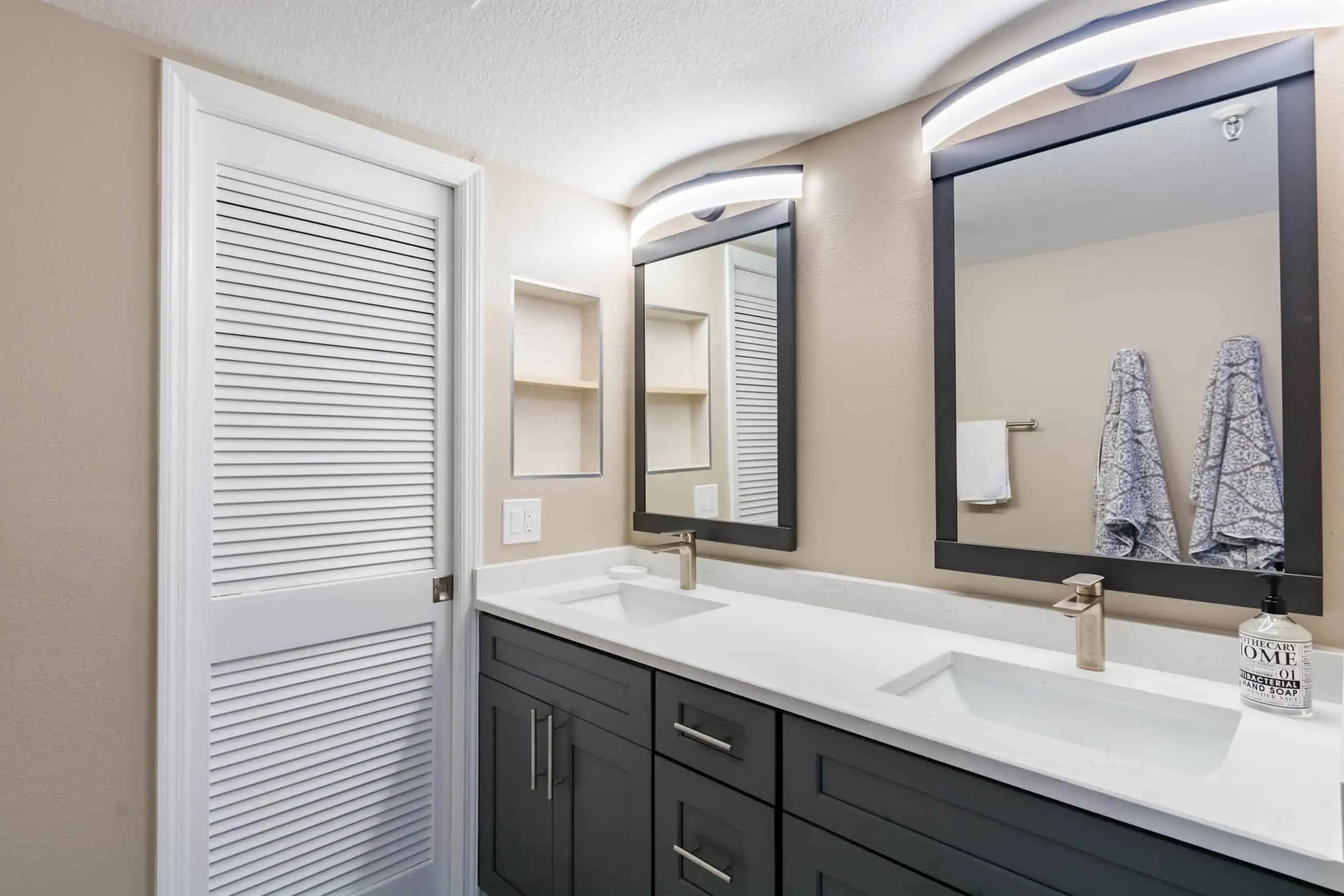 bathroom remodeling in pelican beach with 2 mirrors
