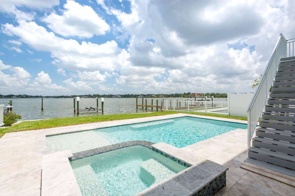 Home Builder in Indian Rocks Beach exterior view with pool and deck by the water