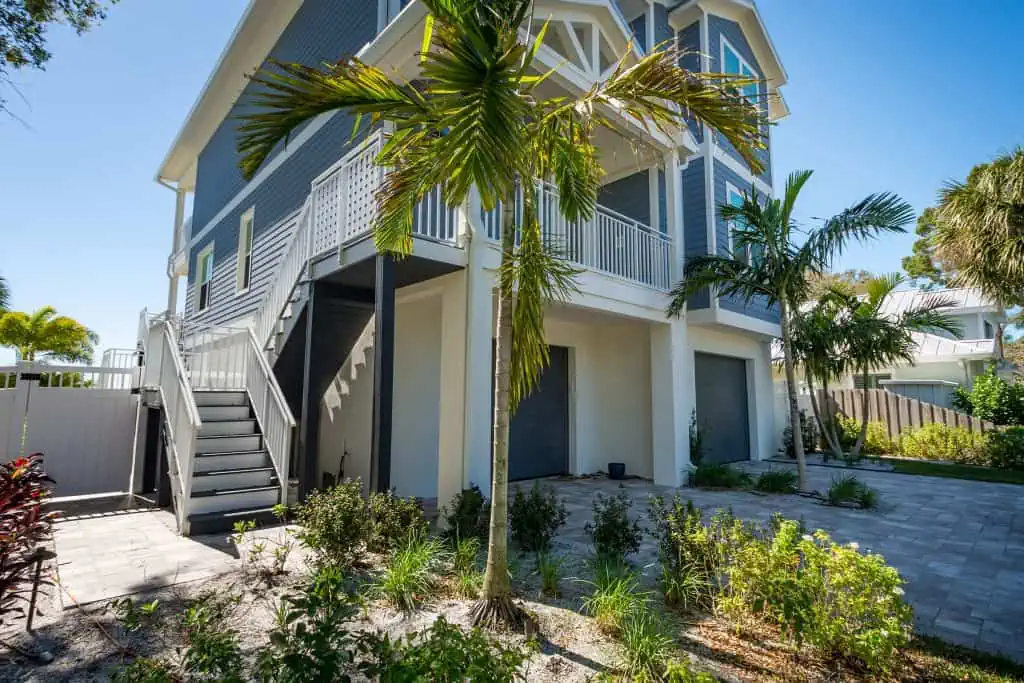 Home Builder in Indian Rocks Beach shows exterior with left staircase leading to entry